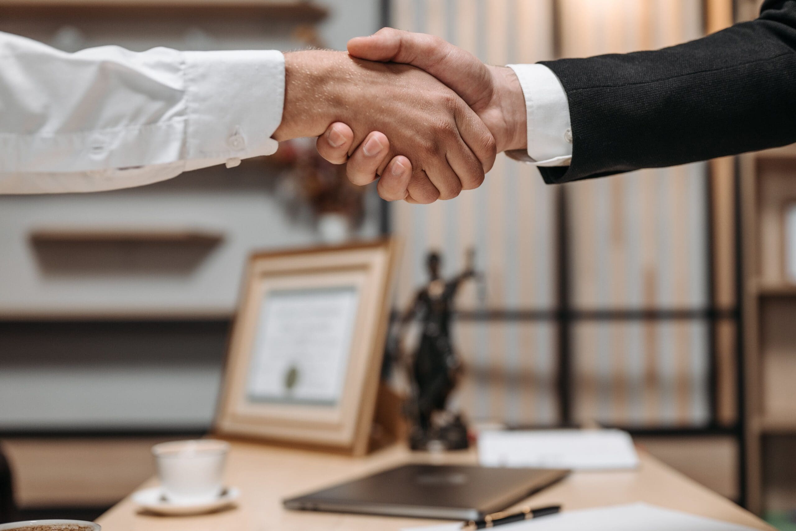 An attorney shakes hands with a client after a legal consultation
